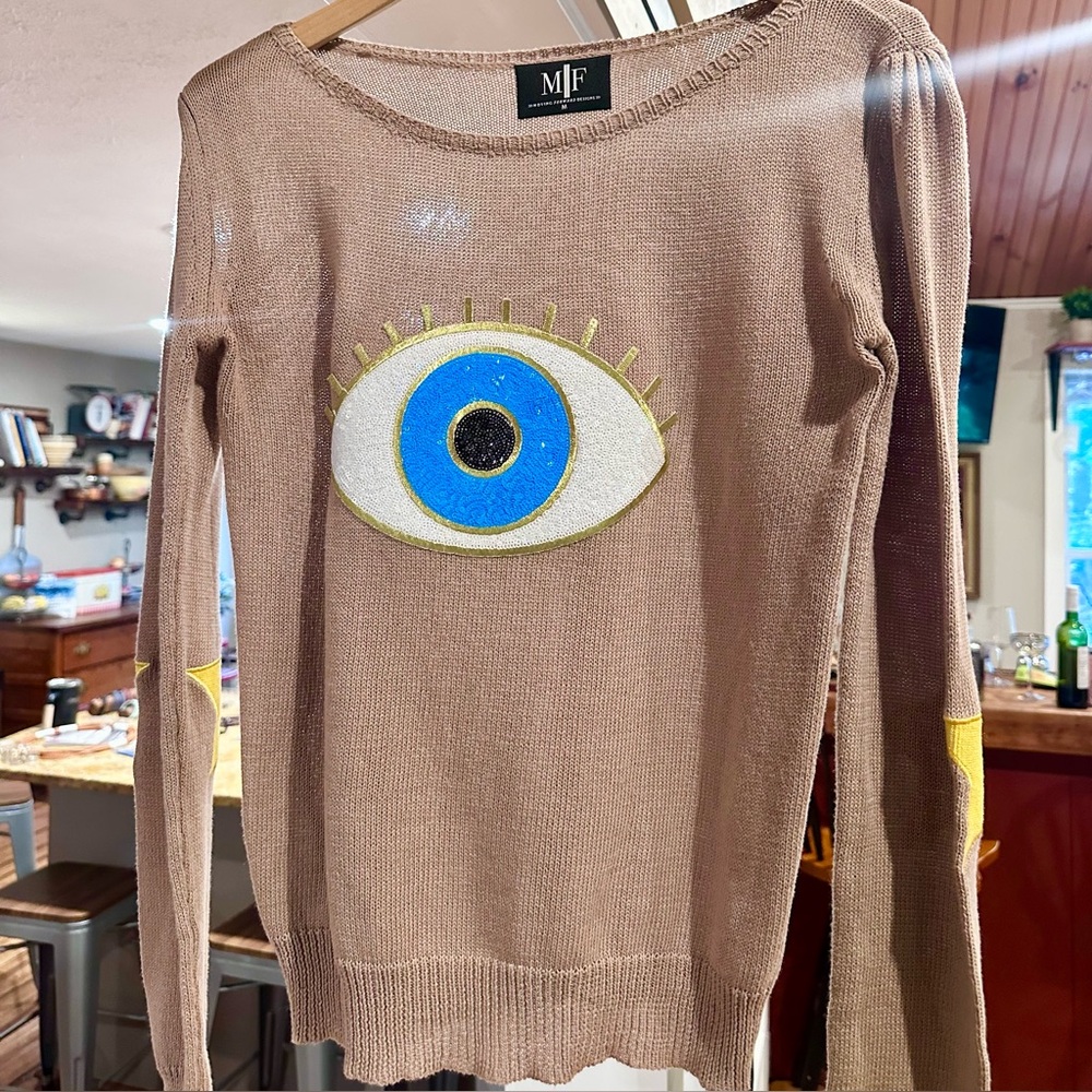Moving Forward Tan Sweater with Blue and Gold Evil Eye Design